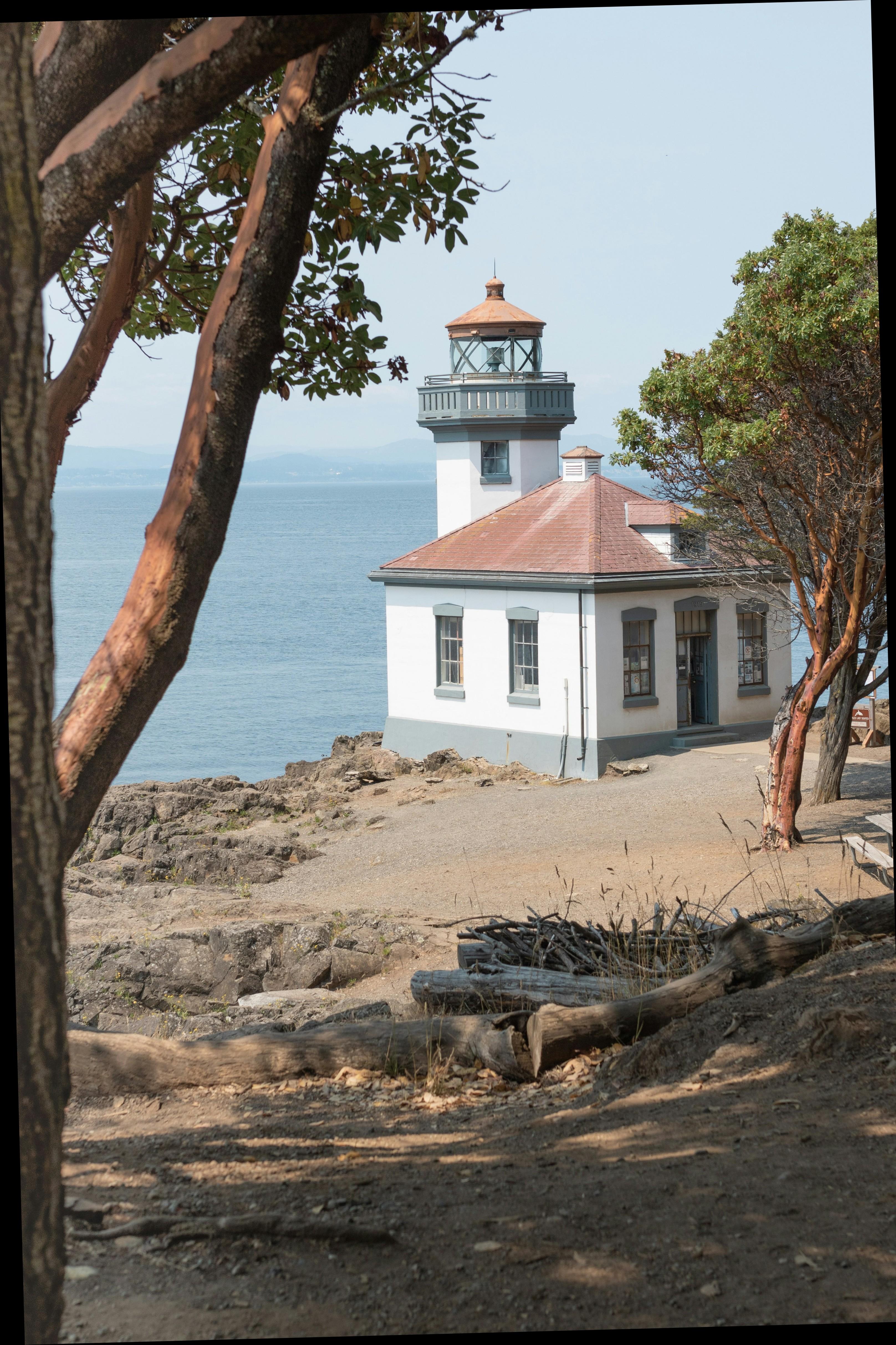 Lime Kiln lighthouse on San Juan Island framed by madrone trees